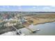 Breathtaking aerial shot of a waterfront property with a private dock and scenic marsh views at 2399 Furman Dr, Charleston, SC 29414