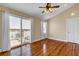 Bedroom with wood flooring, balcony access with waterfront view, ceiling fan, and natural light at 2399 Furman Dr, Charleston, SC 29414