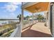 Spacious covered deck featuring a ceiling fan, offering a comfortable retreat with scenic waterfront views at 2399 Furman Dr, Charleston, SC 29414