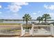 Breathtaking deck view of waterway, dock, and lush palm trees, perfect for enjoying the coastal scenery at 2399 Furman Dr, Charleston, SC 29414