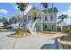 Inviting home with a spacious driveway, featuring a charming front entrance and palm trees at 2399 Furman Dr, Charleston, SC 29414