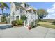 Exterior elevation with multi-level decks and stairs, nestled amidst lush landscaping and mature trees at 2399 Furman Dr, Charleston, SC 29414