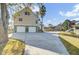 Home exterior featuring a spacious driveway leading to a two-car garage at 2399 Furman Dr, Charleston, SC 29414