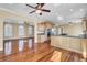 Open kitchen with an island, granite countertops, and hardwood floors, flowing into a spacious living area with lots of sunlight at 2399 Furman Dr, Charleston, SC 29414