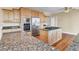 Spacious kitchen features stainless appliances, granite counters, wood cabinets, and a center island with a cooktop at 2399 Furman Dr, Charleston, SC 29414