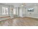 Bright living room showcasing wood floors, bench seating, a ceiling fan and natural light at 2399 Furman Dr, Charleston, SC 29414