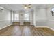 Living room with wood flooring, trim and bench seating beneath large windows at 2399 Furman Dr, Charleston, SC 29414