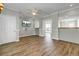Living room featuring wood floors, ceiling fan, television and direct access to outside at 2399 Furman Dr, Charleston, SC 29414
