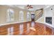 Bright and airy living room with hardwood floors, arched windows, and a fireplace, perfect for gatherings and relaxation at 2399 Furman Dr, Charleston, SC 29414