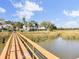 The long boardwalk from the house over the marsh leads to a dock, offering stunning views of the water at 2399 Furman Dr, Charleston, SC 29414
