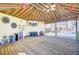 Undercover cabana has an outdoor kitchen with bar, deck, TV, furnishings, lights, and a view of the pool at 2399 Furman Dr, Charleston, SC 29414
