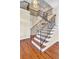 Beautiful staircase with wrought iron railings and hardwood steps and flooring at 2399 Furman Dr, Charleston, SC 29414