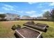 Backyard with garden beds and a sprawling lawn at 2508 Melville Rd, North Charleston, SC 29406