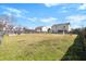Large backyard featuring lush grass, a wooden fence, and the home's exterior, perfect for outdoor activities at 2508 Melville Rd, North Charleston, SC 29406