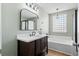 Bathroom features a modern vanity with white countertop, and a glass block window above the bathtub at 2508 Melville Rd, North Charleston, SC 29406