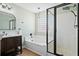 A sleek bathroom features a modern vanity with a walk in shower and a glass block window at 2508 Melville Rd, North Charleston, SC 29406