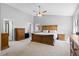 Spacious main bedroom features a ceiling fan, large bed, and a dresser with soft carpeting at 2508 Melville Rd, North Charleston, SC 29406