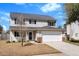Charming two-story home featuring a two-car garage and a well-maintained front yard at 2508 Melville Rd, North Charleston, SC 29406