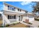 Two-story home with front porch, two-car garage, and well-kept lawn at 2508 Melville Rd, North Charleston, SC 29406