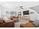 Cozy living room featuring leather seating, ceiling fan, and open floor plan to kitchen at 2508 Melville Rd, North Charleston, SC 29406