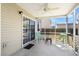 Screened-in porch with a ceiling fan, outdoor furniture, and sliding door to the home's interior at 2508 Melville Rd, North Charleston, SC 29406