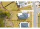 An aerial view shows the layout of the property, lush lawns, a gray roof, and its proximity to the marsh and neighboring homes at 3554 Clambank Dr, Mount Pleasant, SC 29466