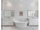 Luxurious bathroom with a soaking tub between two sink vanities and marble tile flooring at 3554 Clambank Dr, Mount Pleasant, SC 29466
