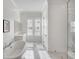 Airy bathroom showcasing marble floors, natural light, and a modern soaking tub at 3554 Clambank Dr, Mount Pleasant, SC 29466