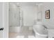 Bright bathroom featuring a glass-enclosed shower and a luxurious soaking tub next to a sink vanity at 3554 Clambank Dr, Mount Pleasant, SC 29466