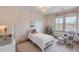 Cozy bedroom with a single bed, chair and footstool, bookshelf, and a beautiful chandelier at 3554 Clambank Dr, Mount Pleasant, SC 29466
