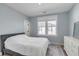 Bedroom features a queen bed, white dresser, blue walls and a window at 3554 Clambank Dr, Mount Pleasant, SC 29466