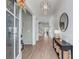 An elegant entryway features wood floors, a modern light fixture, and a console table with decor at 3554 Clambank Dr, Mount Pleasant, SC 29466