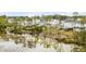 Exterior view of a marsh community filled with white homes and mature landscaping at 3554 Clambank Dr, Mount Pleasant, SC 29466
