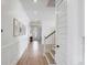 Inviting hallway features wood floors, wainscoting, and natural light leading to the front door at 3554 Clambank Dr, Mount Pleasant, SC 29466