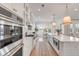 Open kitchen features stainless steel appliances, island with seating, and tile backsplash at 3554 Clambank Dr, Mount Pleasant, SC 29466