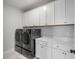 Laundry room with gray washer and dryer, white cabinets and countertop at 3554 Clambank Dr, Mount Pleasant, SC 29466