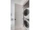 Convenient laundry area with stacked washer and dryer, plus an open view to the tub at 3554 Clambank Dr, Mount Pleasant, SC 29466