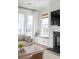 Bright living room with fireplace, large windows, and window seat overlooking the outdoor landscape at 3554 Clambank Dr, Mount Pleasant, SC 29466