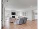 Bright living room features fireplace, neutral furniture, and wood-look floors at 3554 Clambank Dr, Mount Pleasant, SC 29466