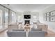 Bright living room featuring a fireplace, neutral furniture, and access to a deck at 3554 Clambank Dr, Mount Pleasant, SC 29466