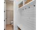 Clean mudroom with shiplap wall, coat hooks, and built-in shelving at 3554 Clambank Dr, Mount Pleasant, SC 29466