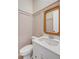 Stylish powder room with decorative mirror, white vanity, and charming wallpaper at 3554 Clambank Dr, Mount Pleasant, SC 29466