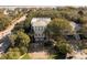 Stunning aerial view of a home near the ocean featuring a rooftop deck surrounded by mature trees at 4008 Cameron Blvd, Isle of Palms, SC 29451