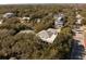 Aerial shot of a luxurious home with a rooftop deck nestled among lush trees in a residential neighborhood at 4008 Cameron Blvd, Isle of Palms, SC 29451