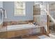 Bathroom showcasing tiled walls, a glass shower, and a standalone tub, offering ample space at 4008 Cameron Blvd, Isle of Palms, SC 29451