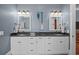Well-lit bathroom with double sinks, a granite countertop, and light blue walls at 4008 Cameron Blvd, Isle of Palms, SC 29451