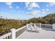 Relax on the spacious deck with ocean views and comfortable white Adirondack chairs at 4008 Cameron Blvd, Isle of Palms, SC 29451