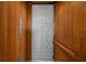 This vintage elevator has wood paneling and a distinctive metal gate for a unique property feature at 4008 Cameron Blvd, Isle of Palms, SC 29451