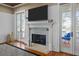 Cozy living room fireplace with a mantle and French doors to exterior deck overlooking yard at 4008 Cameron Blvd, Isle of Palms, SC 29451