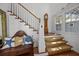 Inviting foyer with wooden floors, white walls, staircase, and nautical decor giving a warm welcome at 4008 Cameron Blvd, Isle of Palms, SC 29451